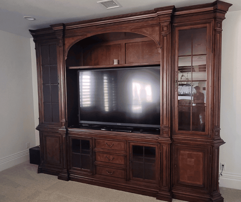a flat screen tv on top of a wood frame