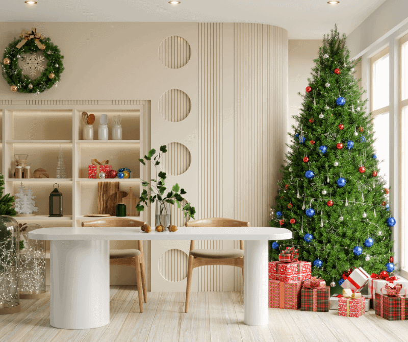 a white living room with a Christmas tree on the right with presents below it